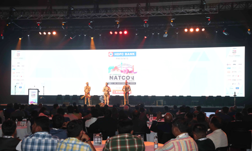 three First Nations performers on stage at the Credai Natcon event