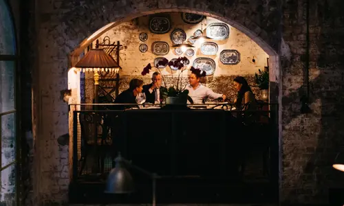 Group of diners talking during a meal at Mr Wong