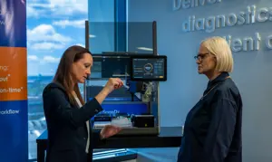 Elisa and Alison standing and looking at diagnostics droppers