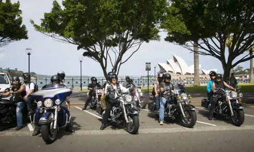 Two rows of Harley Motorbike riders in front of Sydney Harbour and Sydney Opera House