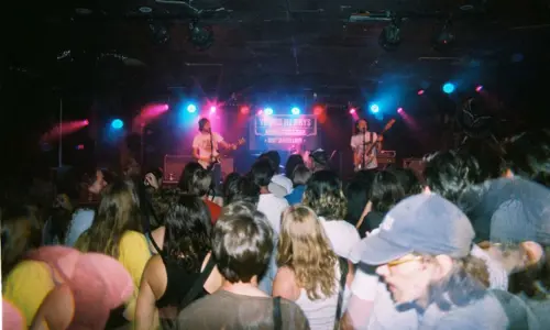 Band on stage with crowd on the dance floor at Young Henrys