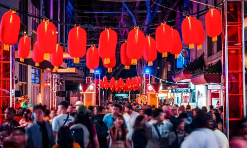 Crowds gathered under red lanterns in Chinatown during Lunar New Year celebrations