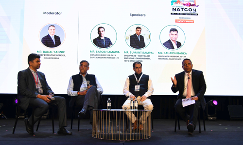 Panel of three speakers and a moderator on stage