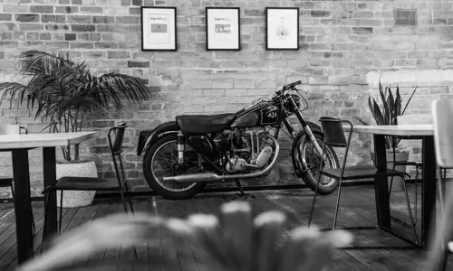 Interior shot of motorbike again brick wall at Young Henrys