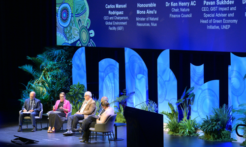 Panel of four speakers and chairperson on stage at the Global Nature Positive Summit