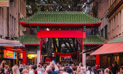 Crowds gathered by entrance gateway of Chinatown in Haymarket 