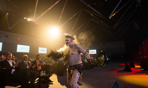 First Nations man delivering the smoking ceremony on stage at the Credai Natcon event