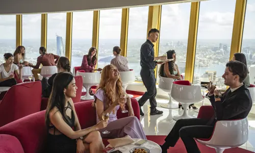 Guests enjoying food and drinks at Bar 83 Sydney Tower 