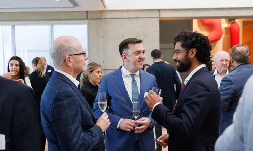 Networking event people listening speaking 