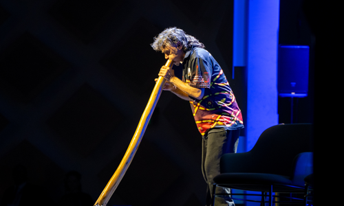 Man playing the Didgeridoo as part of the First Nations ceremony