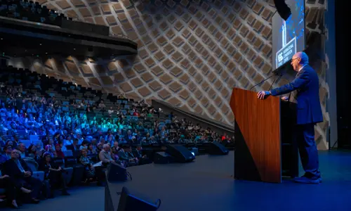 ISPRM World Congress speaker on stage facing theatre of delegates