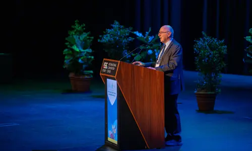 ISPRM World Congress presenter on stage addressing audience