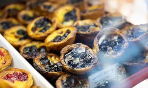 Close up of blueberry Portuguese egg tarts from Petersham